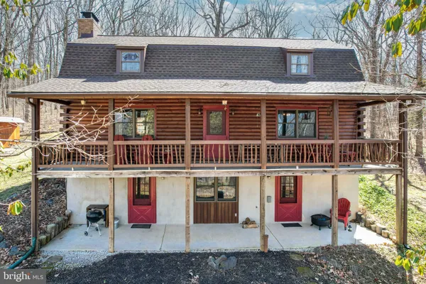 a work room with furniture wooden floor and next to a window