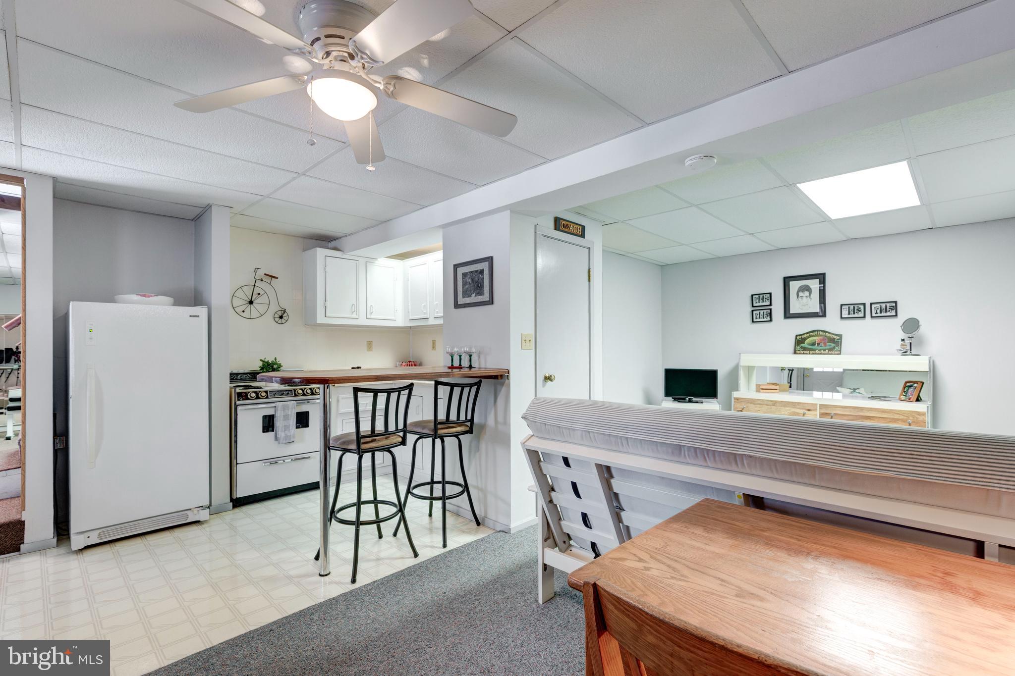385 Silver Run Valley Road Westminster, MD 21158 - Photo 50 of 59 a kitchen with stainless steel appliances granite countertop a table chairs and a refrigerator