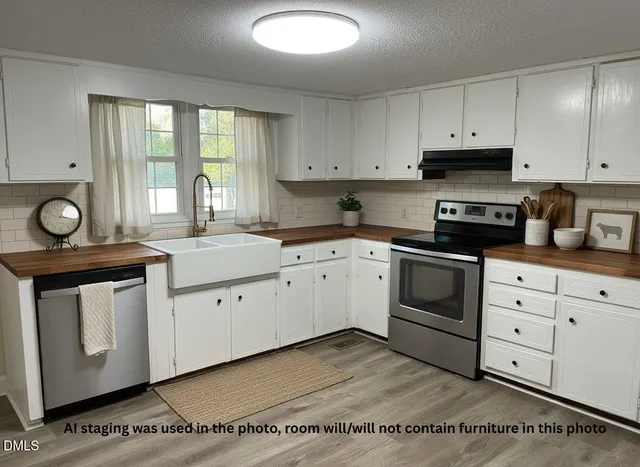 a kitchen with a table and refrigerator