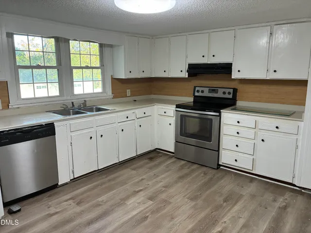 a white refrigerator freezer sitting inside of a kitchen
