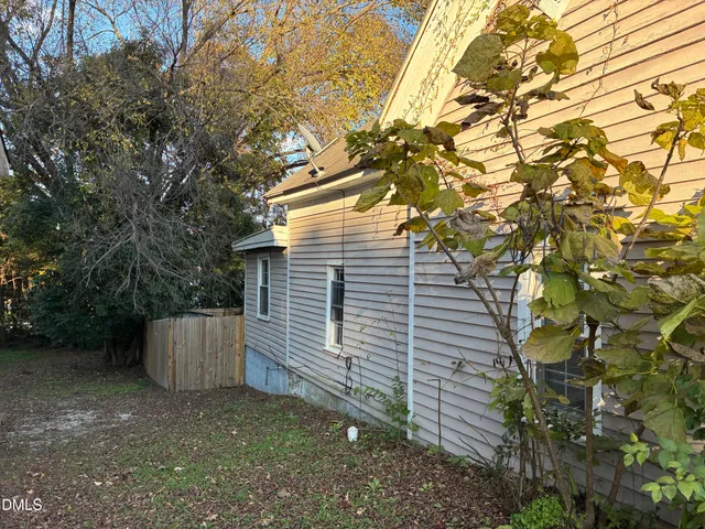 a view of a park that has a car parked on the road