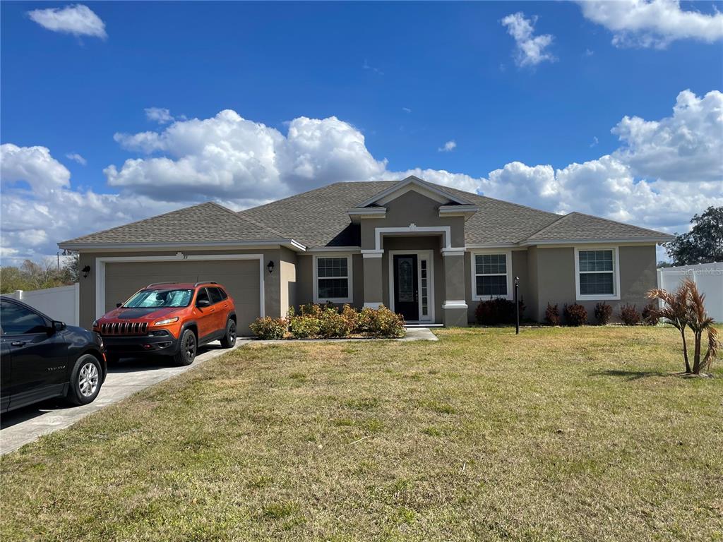 33 Deer Road Frostproof, FL 33843 - Photo 1 of 64 a front view of a house with a yard and garage