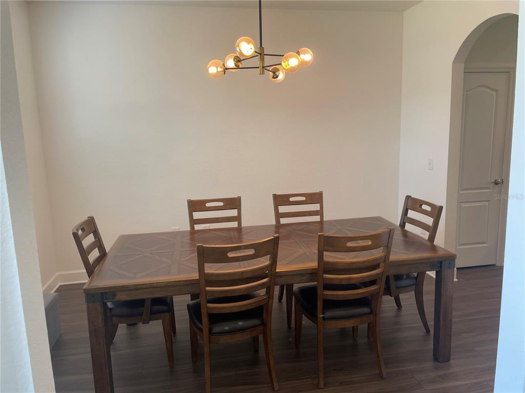 33 Deer Road Frostproof, FL 33843 - Photo 12 of 64 a view of a dining room with furniture and wooden floor