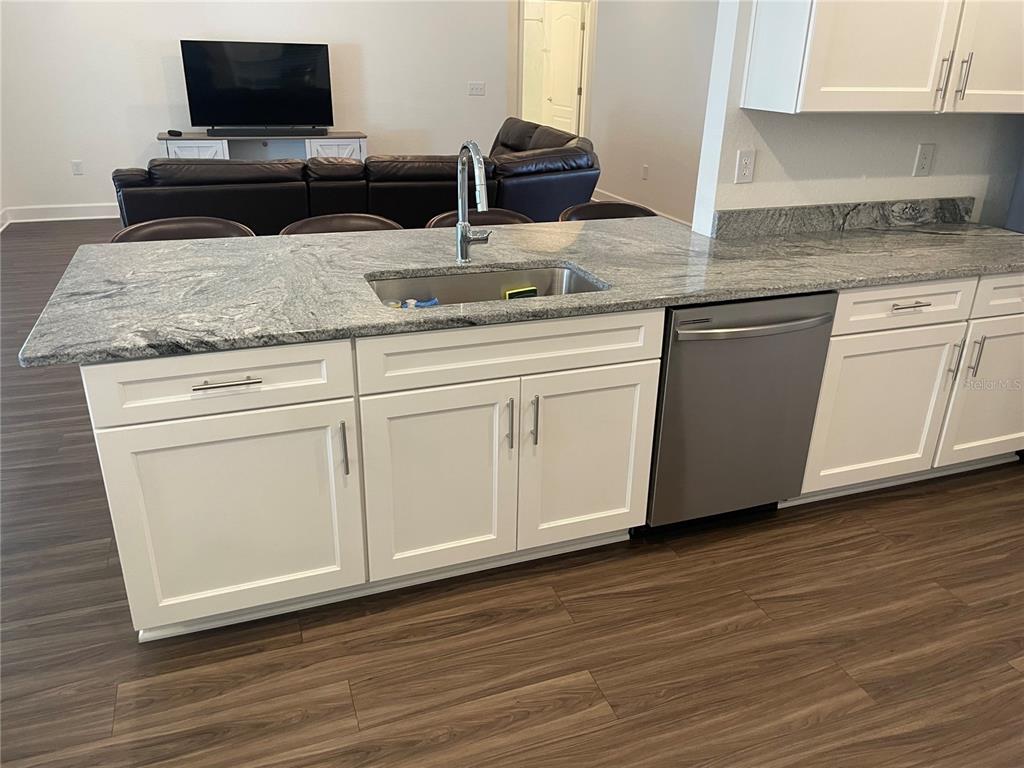 33 Deer Road Frostproof, FL 33843 - Photo 20 of 64 a kitchen with granite countertop a sink and a stove top oven
