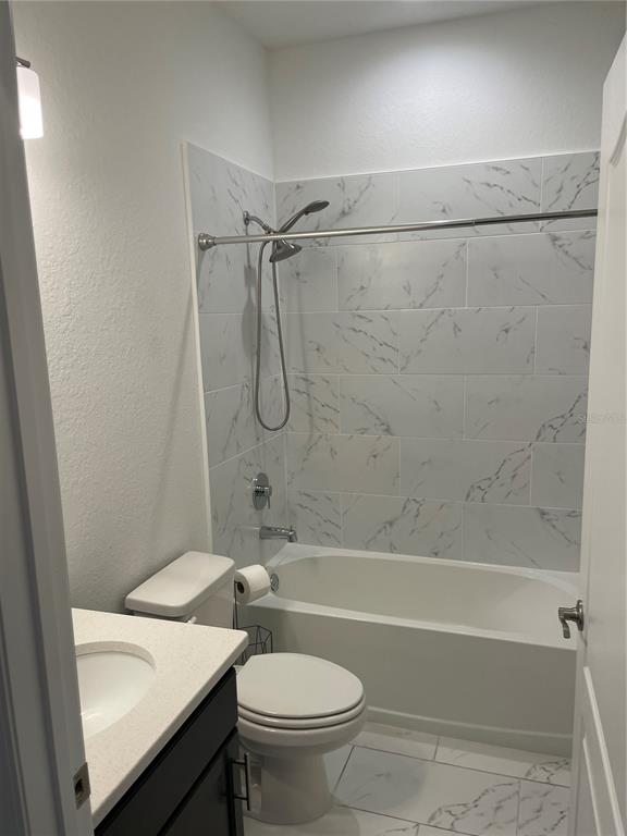 33 Deer Road Frostproof, FL 33843 - Photo 36 of 64 a bathroom with a sink a toilet and a bathtub