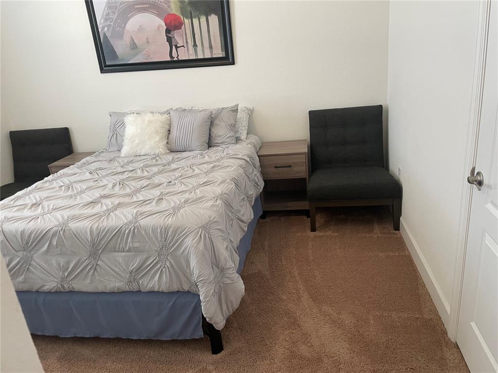 33 Deer Road Frostproof, FL 33843 - Photo 46 of 64 a bedroom with a bed and a couch