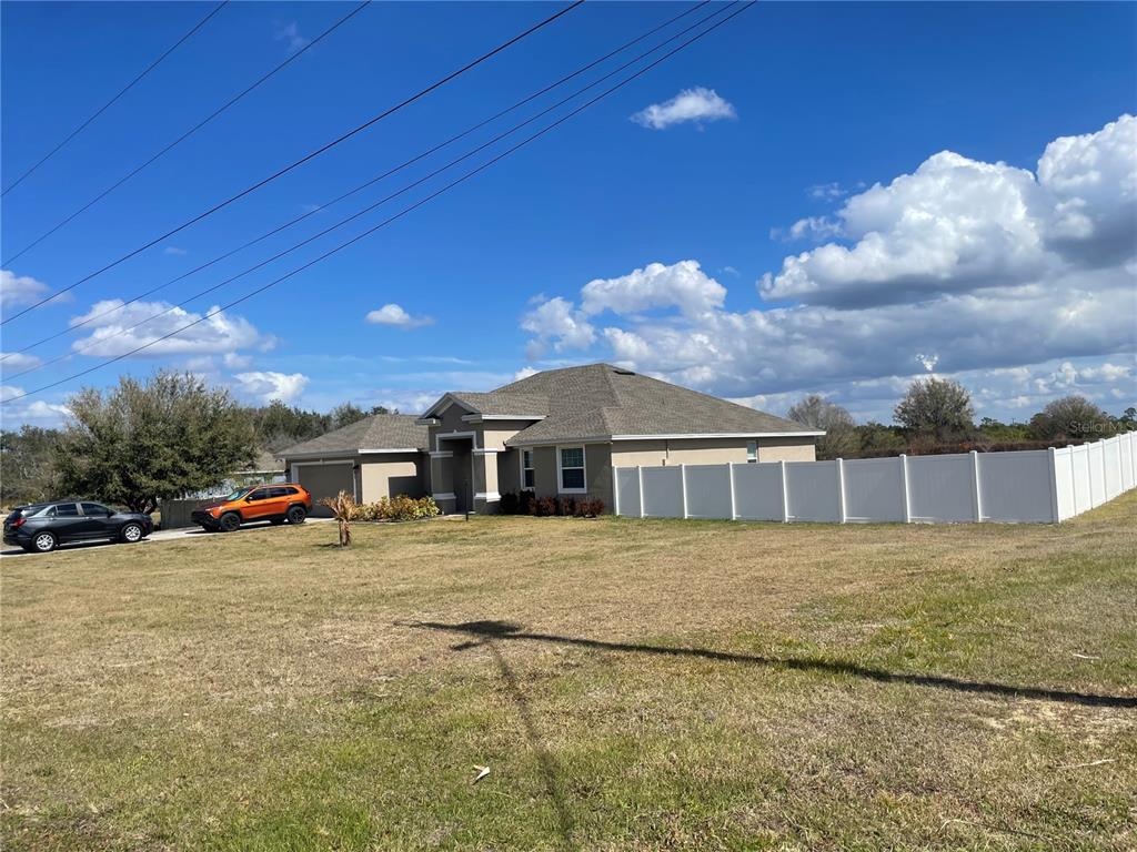 33 Deer Road Frostproof, FL 33843 - Photo 6 of 64 a view of a big house with a big yard and large trees