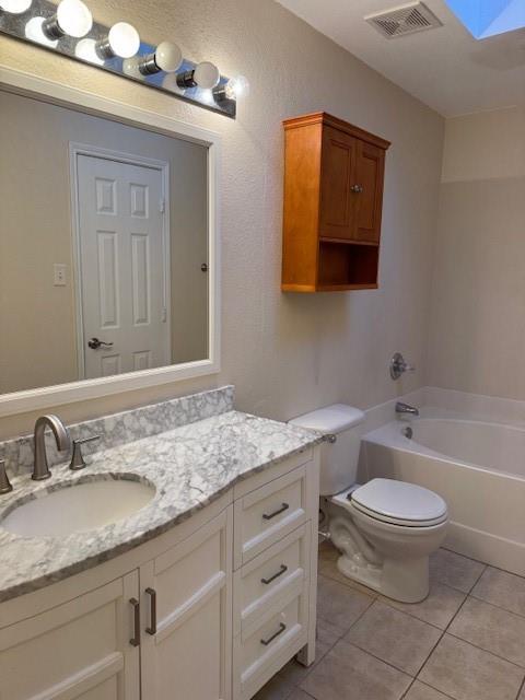 8353 Riversprings Drive Fort Worth, TX 76053 - Photo 11 of 20 Bathroom with vanity, a bath, light tile patterned floors, and a skylight