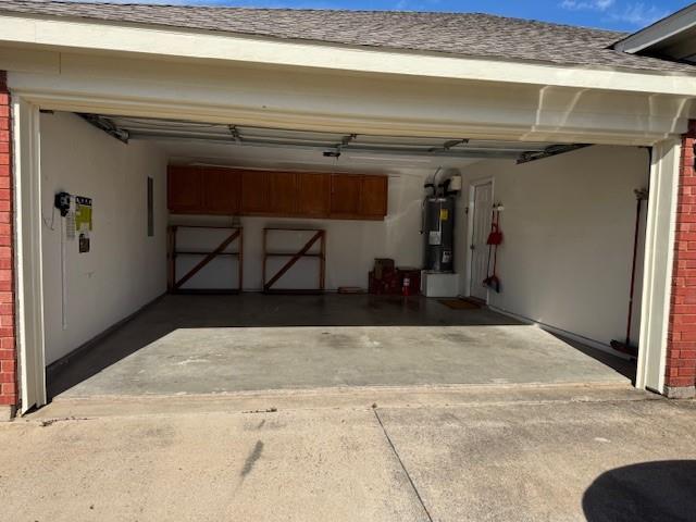 8353 Riversprings Drive Fort Worth, TX 76053 - Photo 12 of 20 Garage with concrete driveway and water heater