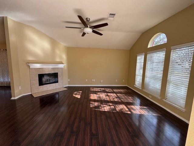 8353 Riversprings Drive Fort Worth, TX 76053 - Photo 13 of 20 Unfurnished living room featuring ceiling fan, dark wood-style flooring, lofted ceiling, and a fireplace