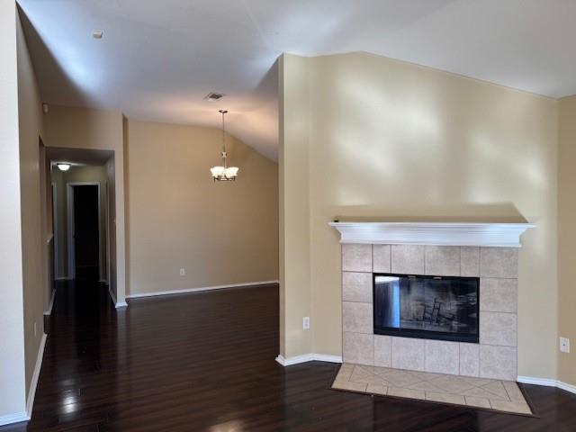 8353 Riversprings Drive Fort Worth, TX 76053 - Photo 14 of 20 Unfurnished living room featuring dark wood finished floors, lofted ceiling, a fireplace, and hanging lights
