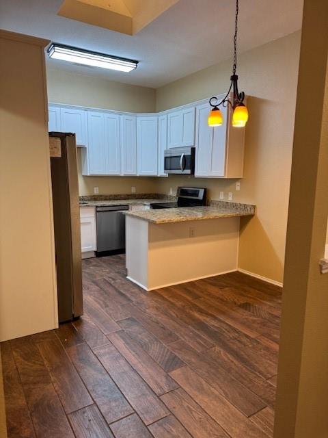 8353 Riversprings Drive Fort Worth, TX 76053 - Photo 8 of 20 Kitchen featuring dark wood-style floors, a peninsula, light stone countertops, and stainless steel appliances