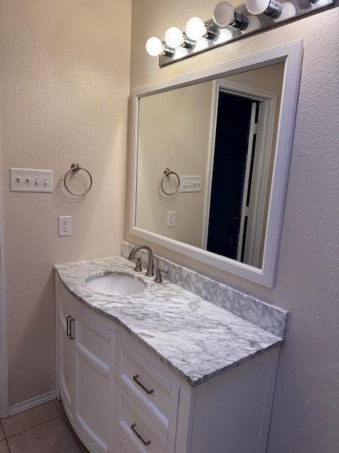 8353 Riversprings Drive Fort Worth, TX 76053 - Photo 10 of 20 Bathroom featuring a textured wall, vanity, and light tile patterned flooring