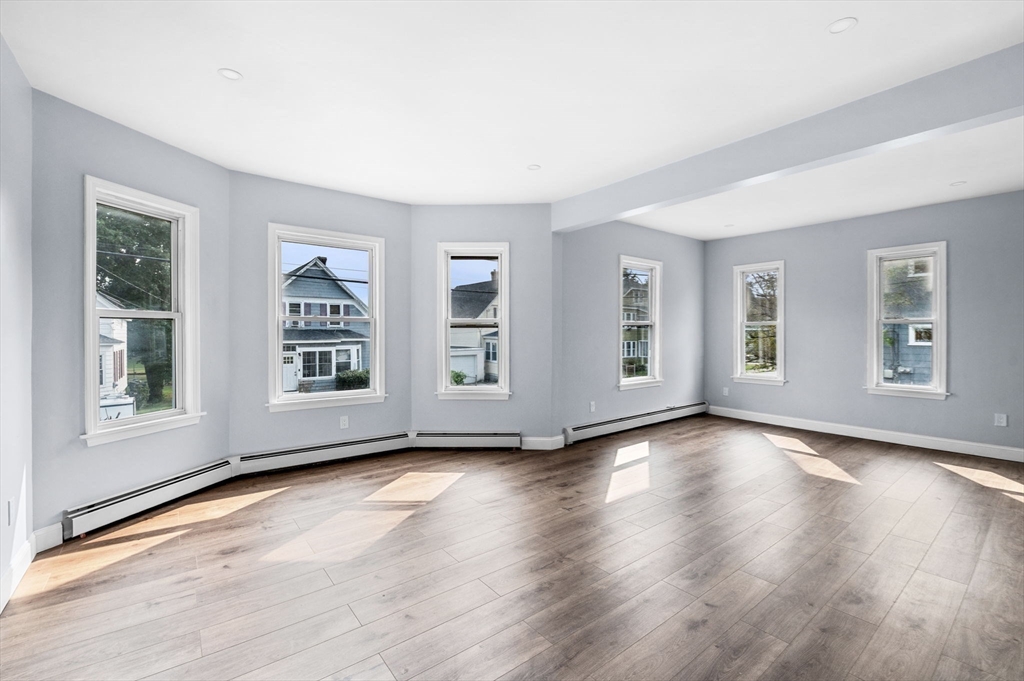 83 Arnold Street Methuen, MA 01844 - Photo 13 of 42 a view of an empty room with window and wooden floor