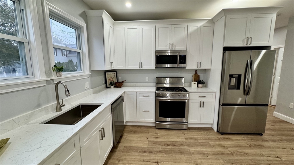 83 Arnold Street Methuen, MA 01844 - Photo 18 of 42 a kitchen with a refrigerator stove and sink