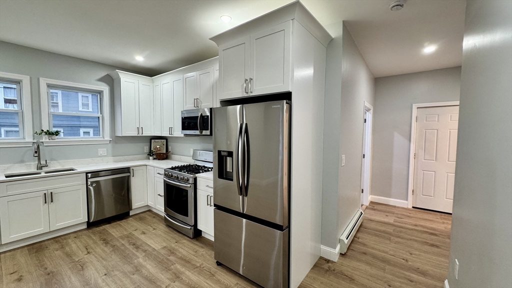 83 Arnold Street Methuen, MA 01844 - Photo 19 of 42 a kitchen with stainless steel appliances granite countertop a refrigerator stove and sink