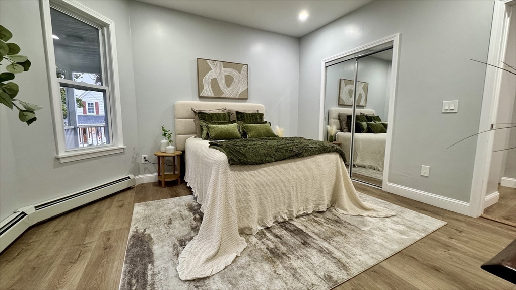 83 Arnold Street Methuen, MA 01844 - Photo 20 of 42 a bedroom with a bed and wooden floor