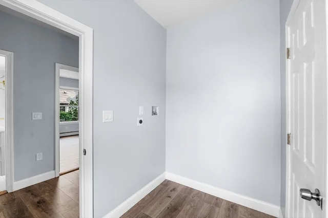 a view of a room with wooden floor
