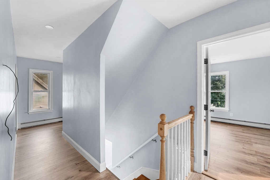 83 Arnold Street Methuen, MA 01844 - Photo 26 of 42 a view of a hallway with wooden floor and a living room