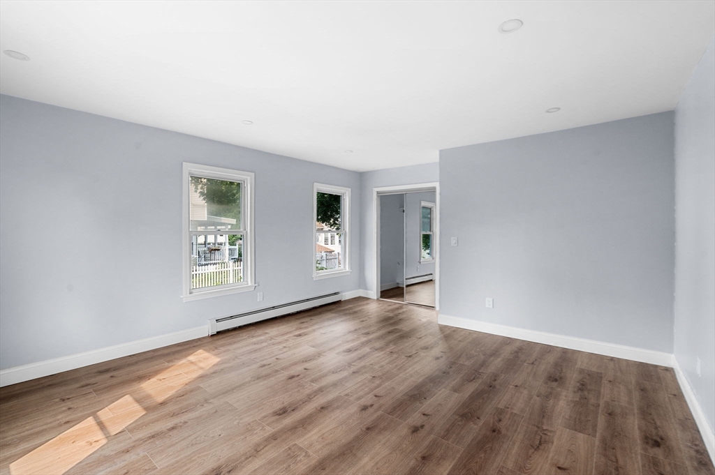 83 Arnold Street Methuen, MA 01844 - Photo 29 of 42 an empty room with wooden floor and windows