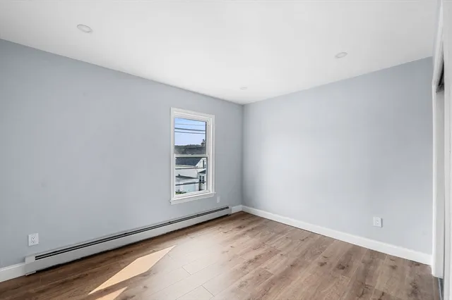 a view of a hallway with wooden floor and entryway