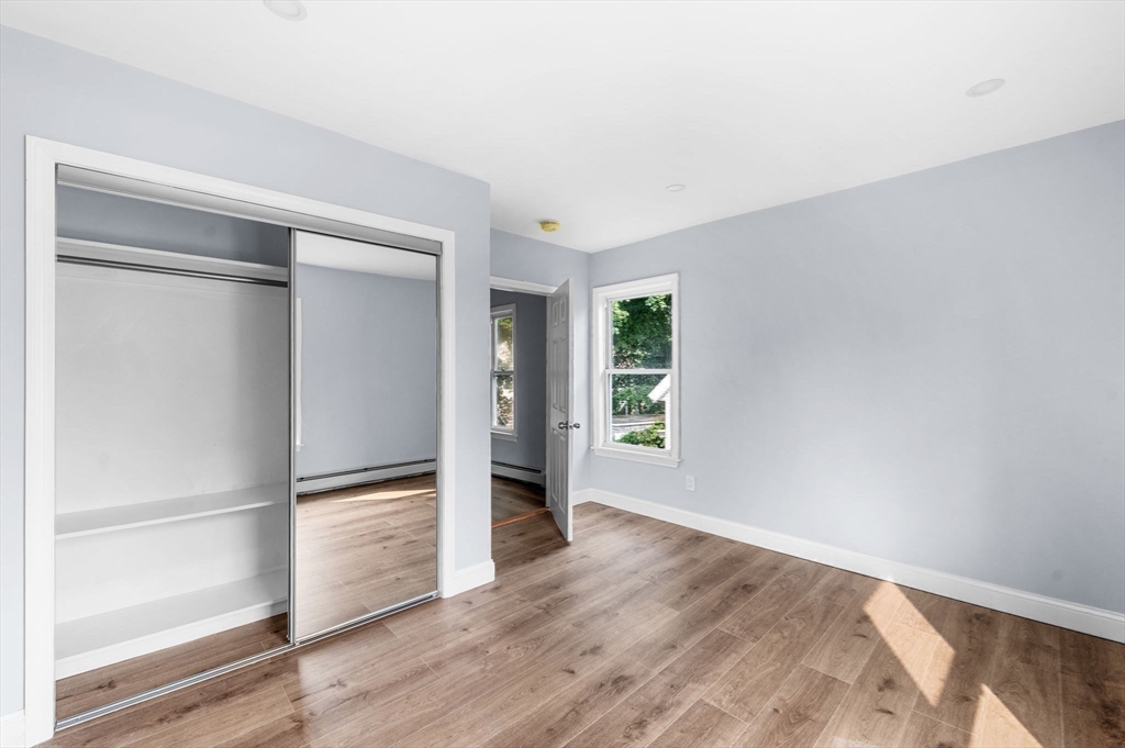 83 Arnold Street Methuen, MA 01844 - Photo 31 of 42 an empty room with wooden floor closet and windows
