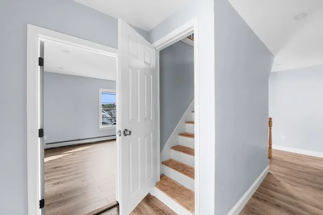 a view of a hallway with wooden floor
