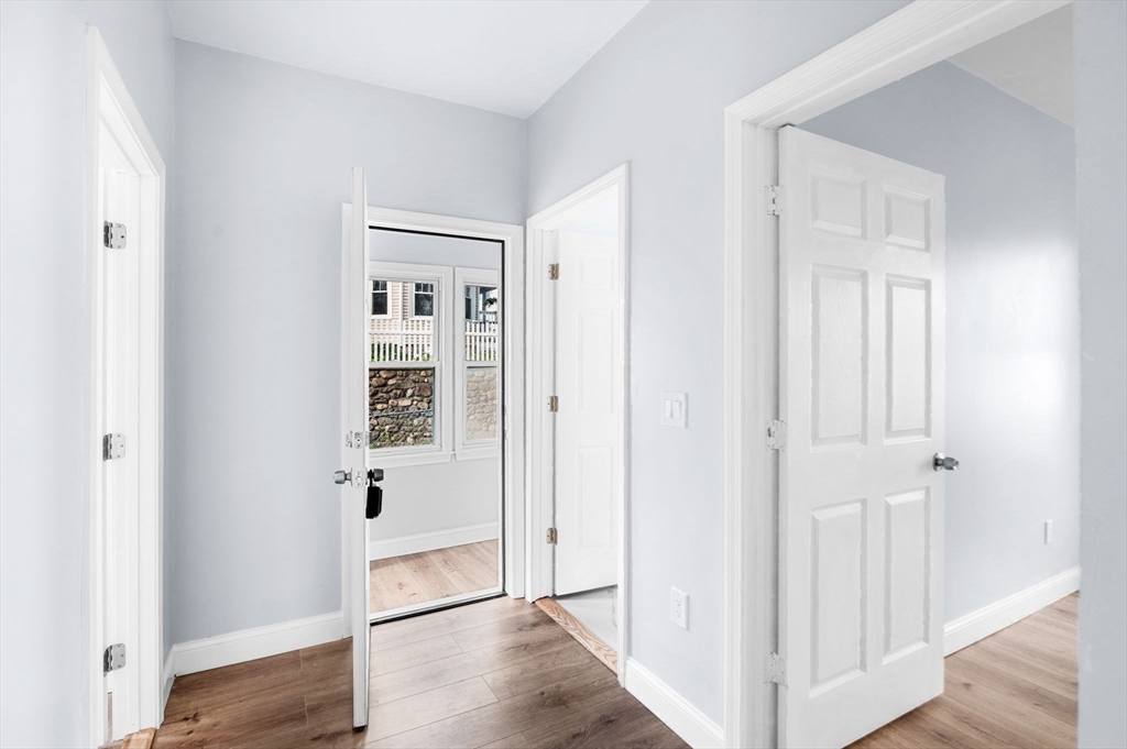 83 Arnold Street Methuen, MA 01844 - Photo 37 of 42 a view of a hallway with wooden floor and closet area