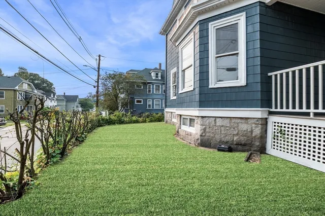 a view of backyard of house with green space