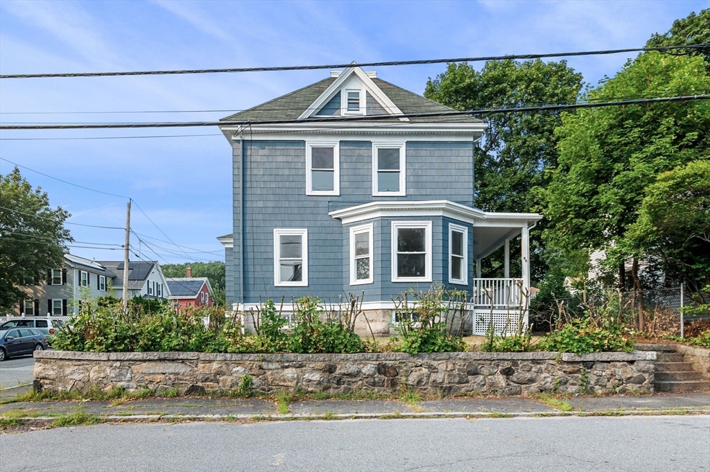 83 Arnold Street Methuen, MA 01844 - Photo 4 of 42 a front view of a house with a yard and potted plants