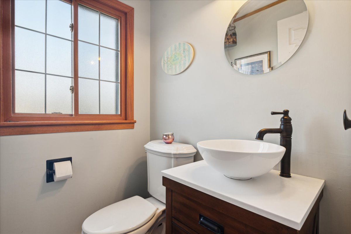 203 Pine Street Deerfield, IL 60015 - Photo 11 of 24 a bathroom with a toilet a sink and a mirror