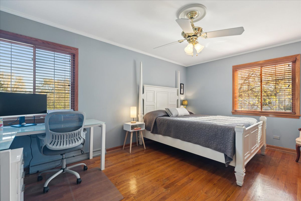 203 Pine Street Deerfield, IL 60015 - Photo 12 of 24 a bedroom with a bed chandelier and a window
