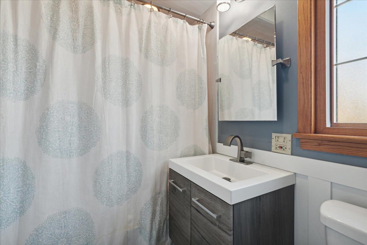 203 Pine Street Deerfield, IL 60015 - Photo 15 of 24 a bathroom with a sink a vanity and a shower curtain