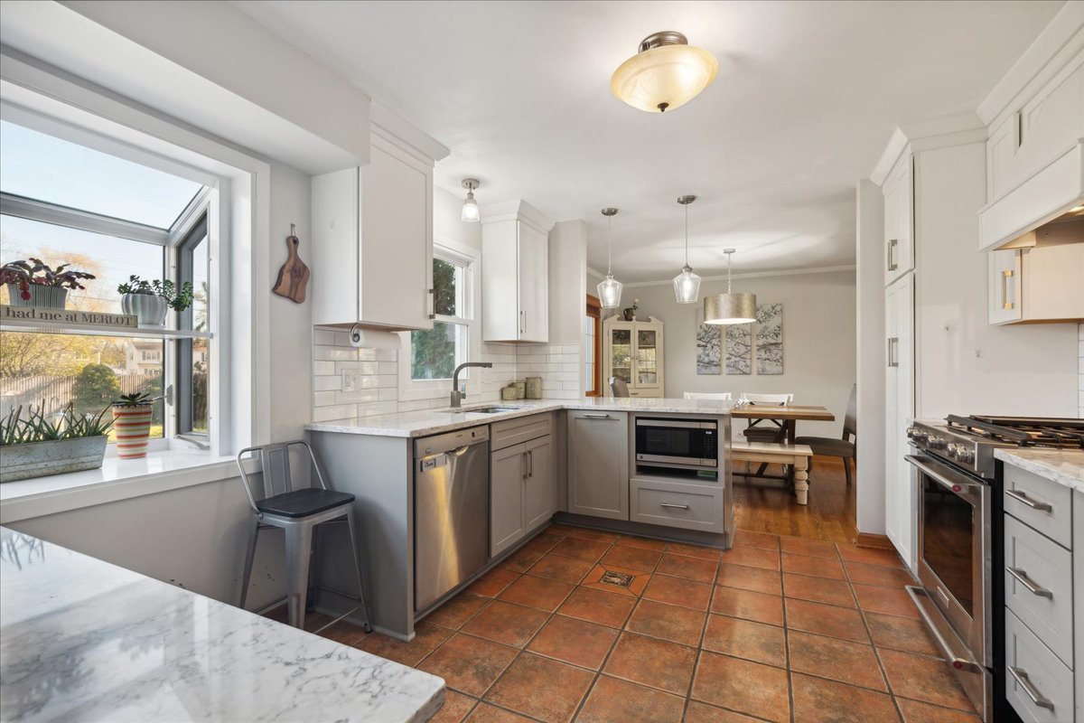 203 Pine Street Deerfield, IL 60015 - Photo 7 of 24 a large kitchen with stainless steel appliances granite countertop a stove and a sink