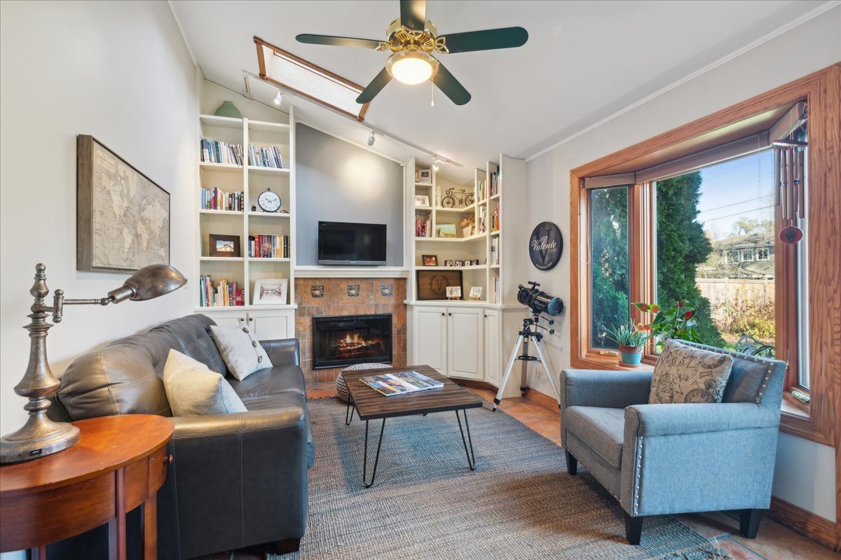 203 Pine Street Deerfield, IL 60015 - Photo 10 of 24 a living room with furniture a fireplace and a flat screen tv