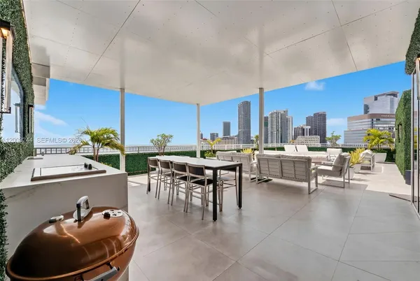 a room with lots of furniture and view kitchen