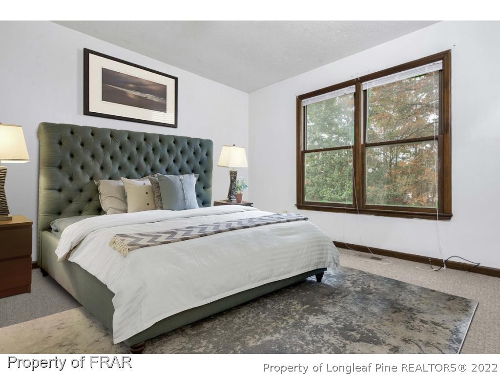 1758 Rim Road Fayetteville, NC 28314 - Photo 11 of 25 a bedroom with a bed and a window
