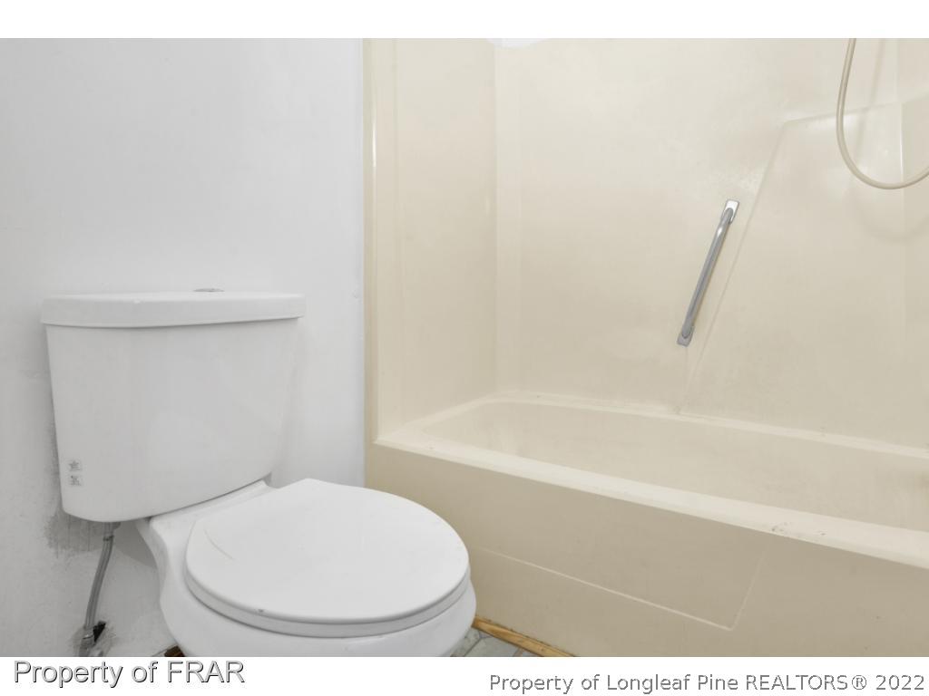 1758 Rim Road Fayetteville, NC 28314 - Photo 13 of 25 a bathroom with a toilet and a shower