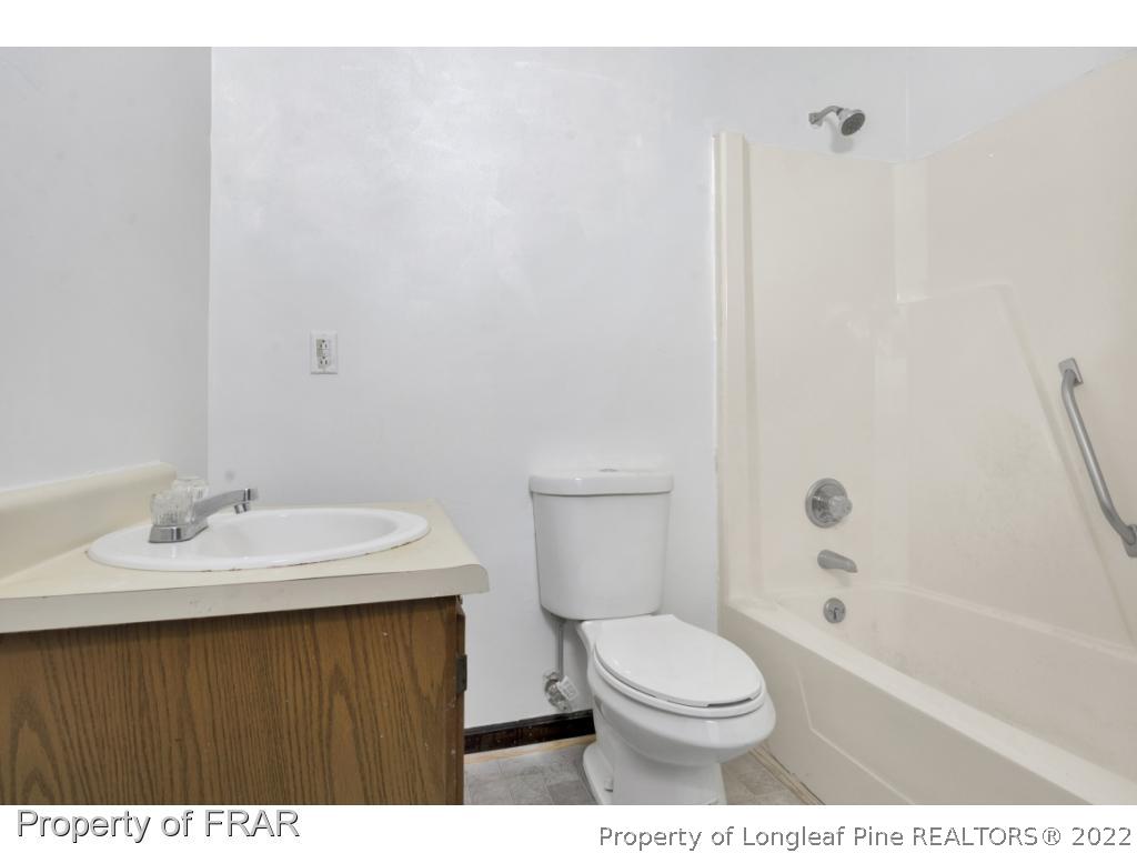 1758 Rim Road Fayetteville, NC 28314 - Photo 18 of 25 a bathroom with a sink a toilet and shower