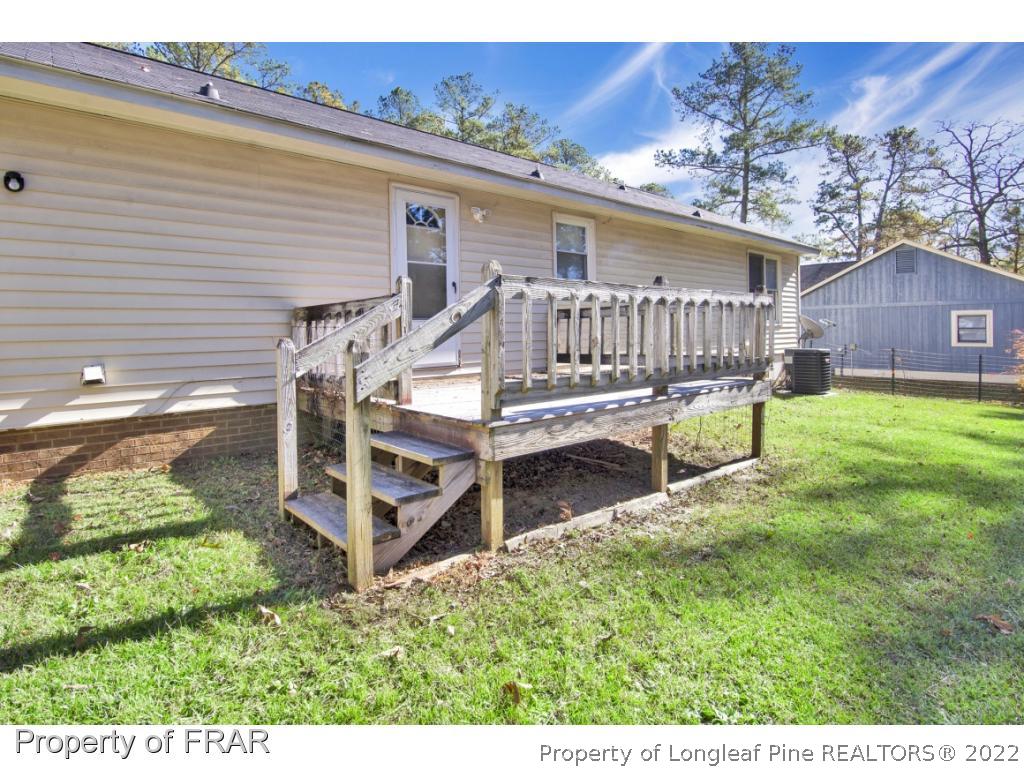 1758 Rim Road Fayetteville, NC 28314 - Photo 20 of 25 a view of a house with backyard and wooden fence