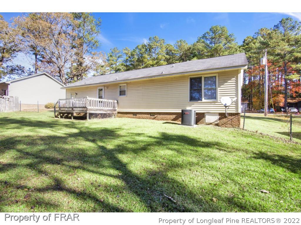 1758 Rim Road Fayetteville, NC 28314 - Photo 23 of 25 a backyard of a house with table and chairs