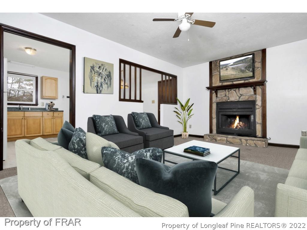 1758 Rim Road Fayetteville, NC 28314 - Photo 5 of 25 a living room with furniture and a fireplace