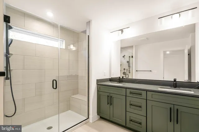 a bathroom with a shower sink and mirror