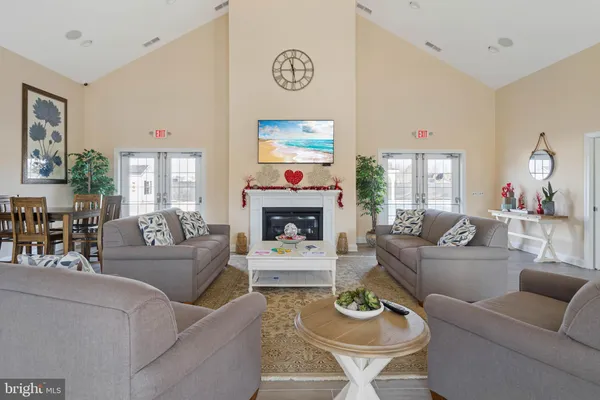 a living room with furniture a fireplace and a large window