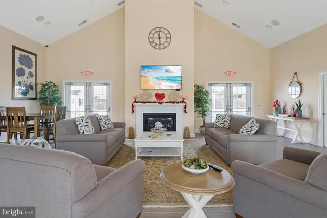 a living room with furniture a fireplace and a large window