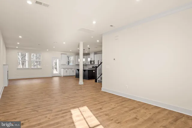 a view of kitchen and hall with wooden floor