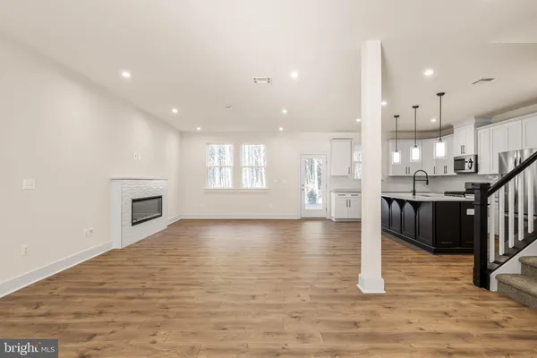 a view of a kitchen with kitchen island and stainless steel appliances