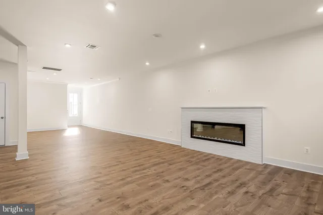 a view of an empty room and fire place