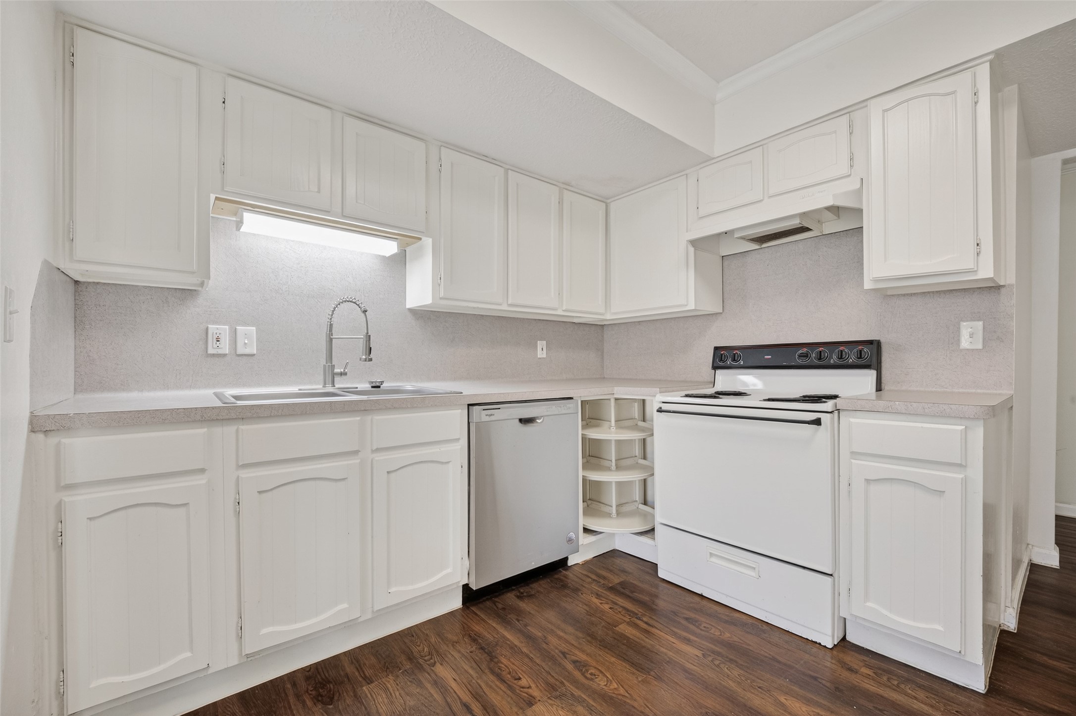 1106 East Red Cedar Circle Spring, TX 77380 - Photo 17 of 43 a kitchen with granite countertop white cabinets and white appliances