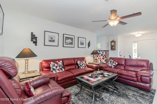 a living room with furniture a rug and a lamp